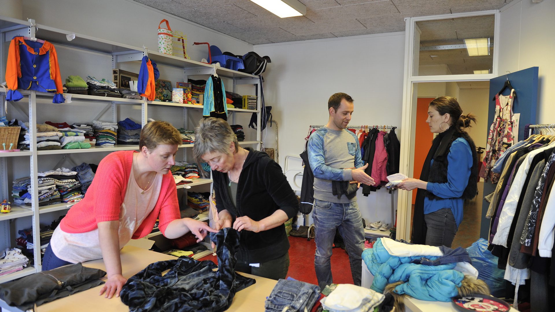 Sfeerbeeld van een bewonersinitiatief, mensen die kleding ruilen in de ruilwinkel het Heerdenhoes in Beijum.