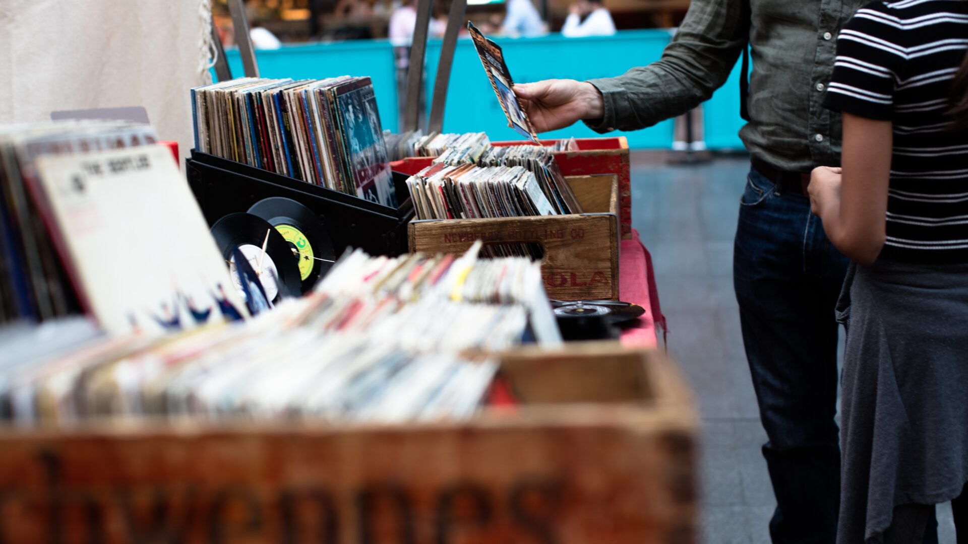 Decoratieve afbeelding van mensen die tussen vinylplaten kijken op een rommelmarkt